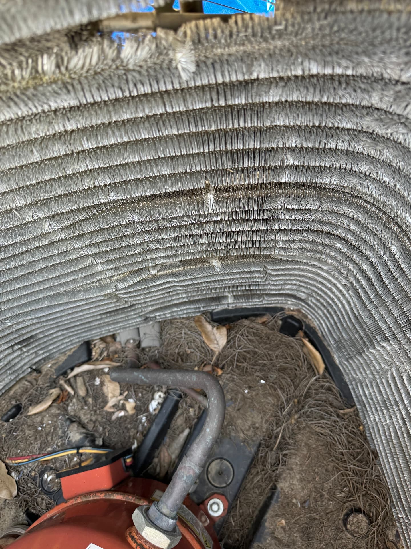 Heavily soiled condenser coil packed with debris before cleaning